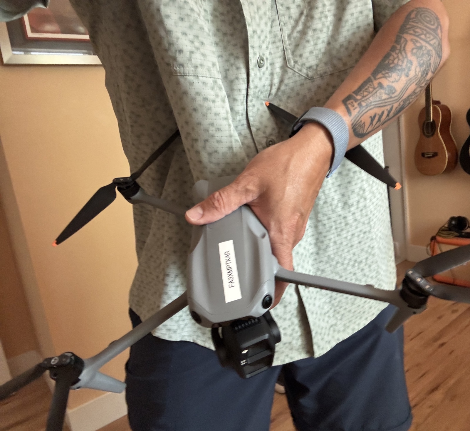 Dragonfly Drone Lab's DJI Air 3S held in one hand, showing its actual size