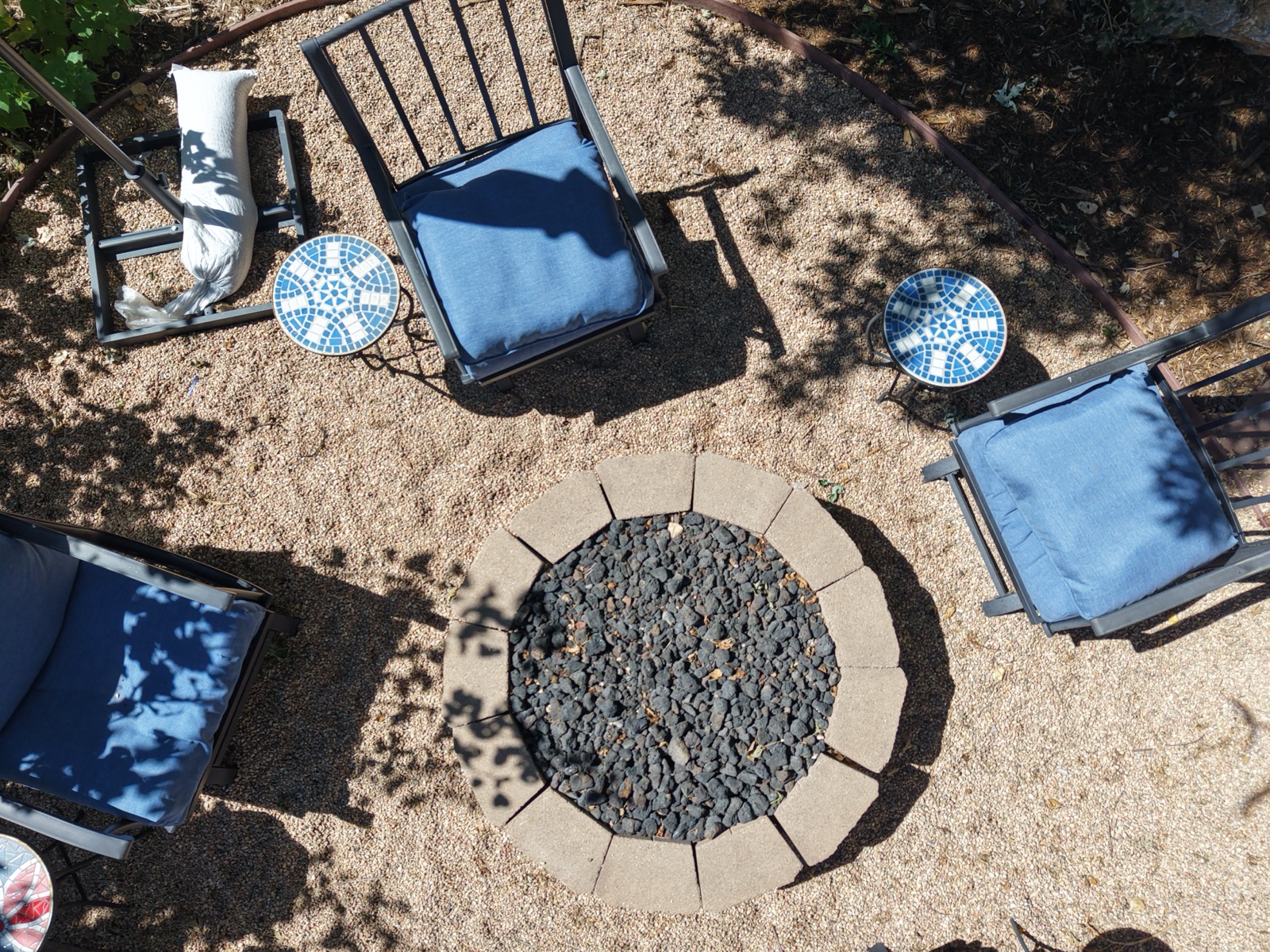Overhead view of a backyard fire pit and patio seating area