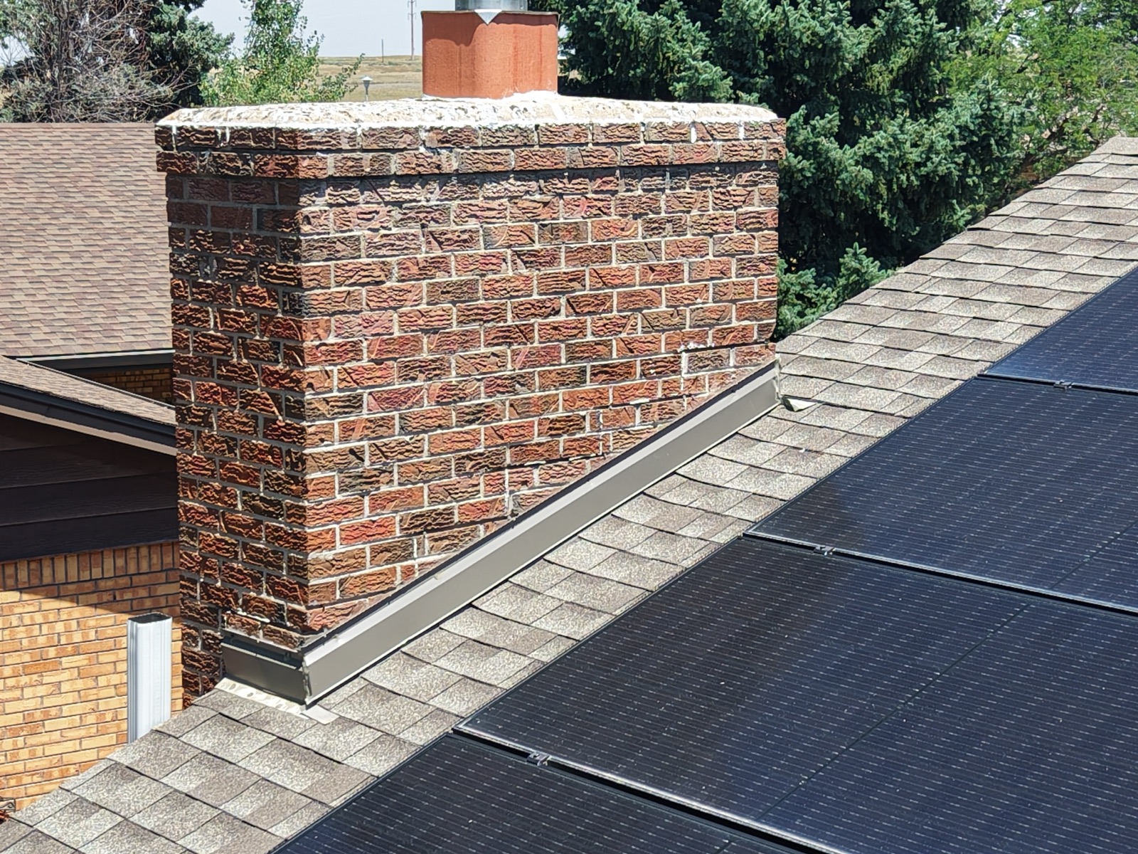 Close-up drone inspection of a chimney and roofline