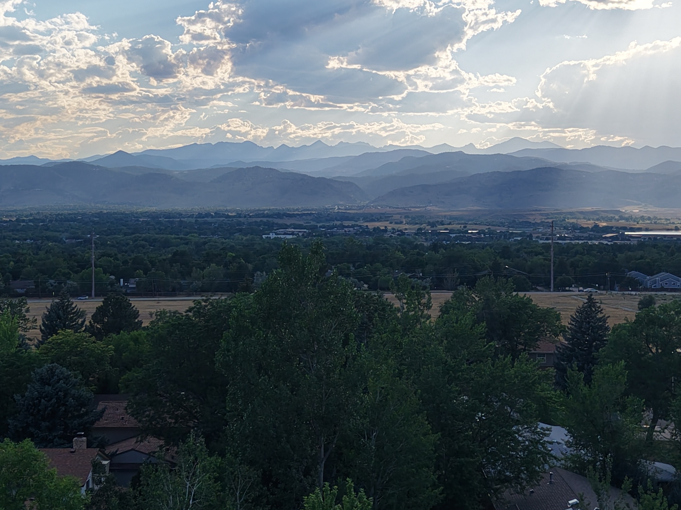 Aerial photograph of Colorado's Front Range at golden hour, with a reservoir catching the light