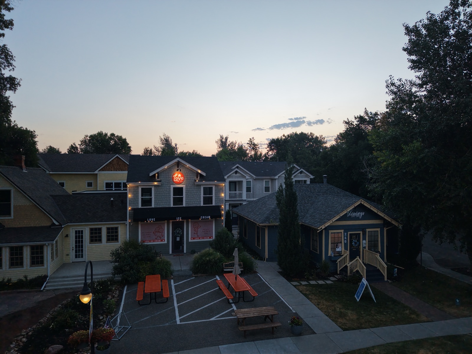 Blue-hour aerial photograph of the Love Ice Cream storefront in downtown Niwot