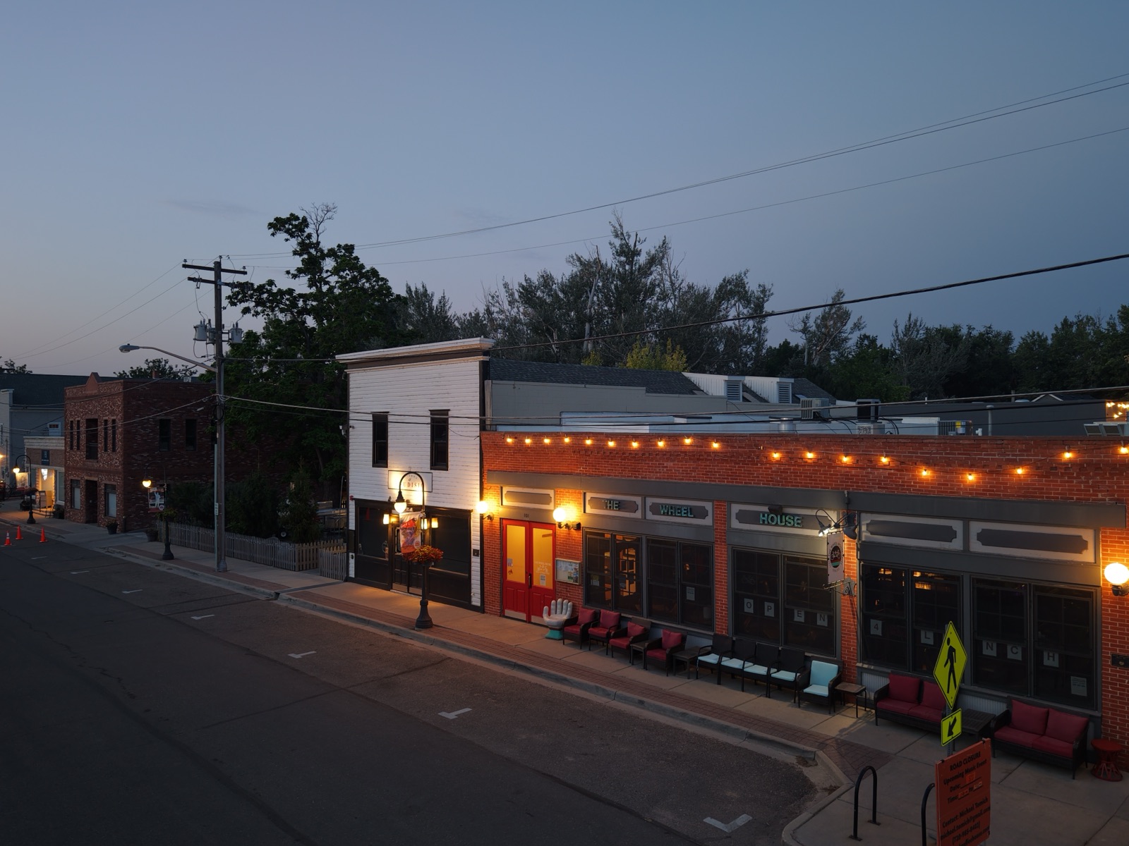 Blue-hour aerial photograph of the Wheel House storefront in downtown Niwot