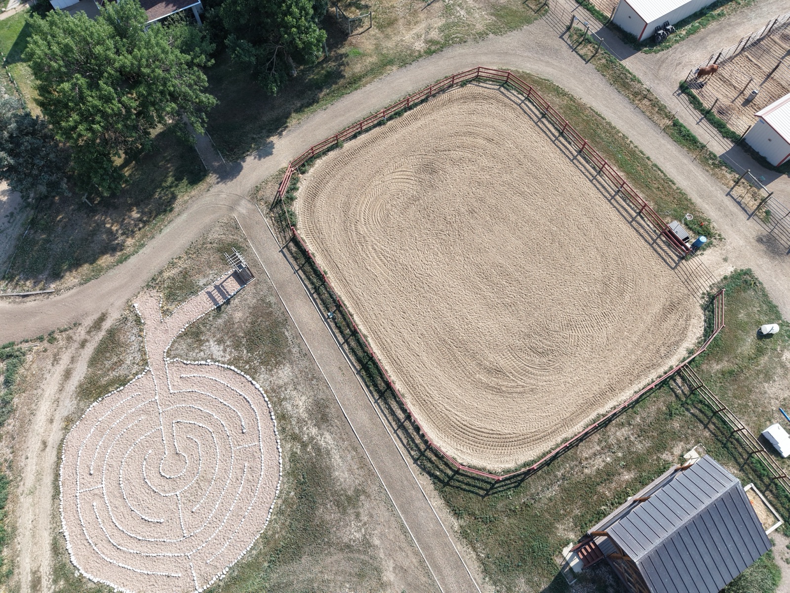 Overhead aerial view of a riding arena and stone labyrinth