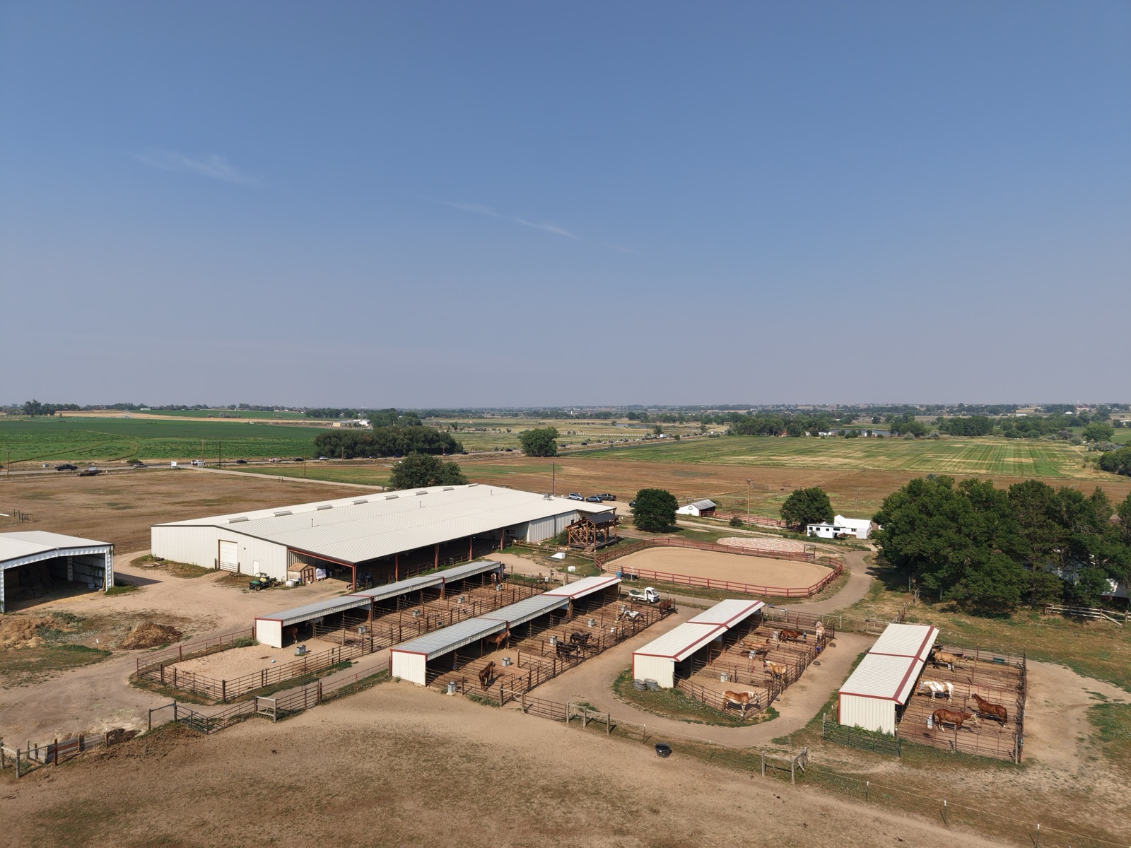 Wide aerial overview of a Front Range horse ranch property