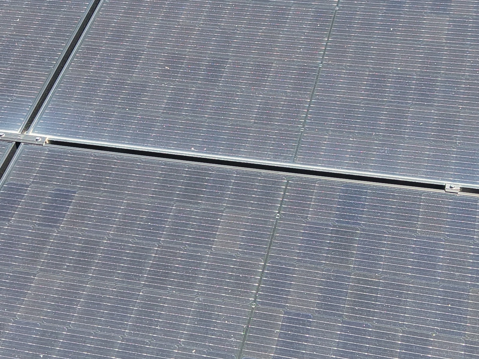Extreme close-up of individual solar panel cells during an inspection flight